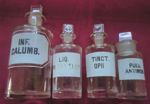 FOUR VINTAGE CLEAR GLASS CHEMIST-APOTHECARY BOTTLES + GLASS STOPPERS & WHITE LABELS  (LOG) SEE PICS