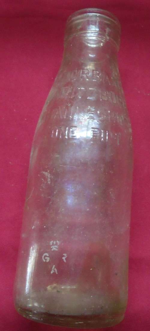 THREE DIFFERENT VINTAGE GLASS MILK BOTTLES -TWO PINT SIZE BOTTLES AND A QUART