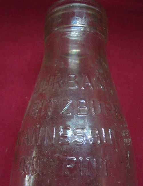 THREE DIFFERENT VINTAGE GLASS MILK BOTTLES -TWO PINT SIZE BOTTLES AND A QUART