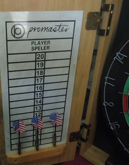 PROMASTER OAK FINISH CABINET-DART BOARD-SCORESHEETS- BOARD CLEANER- 6 DARTS