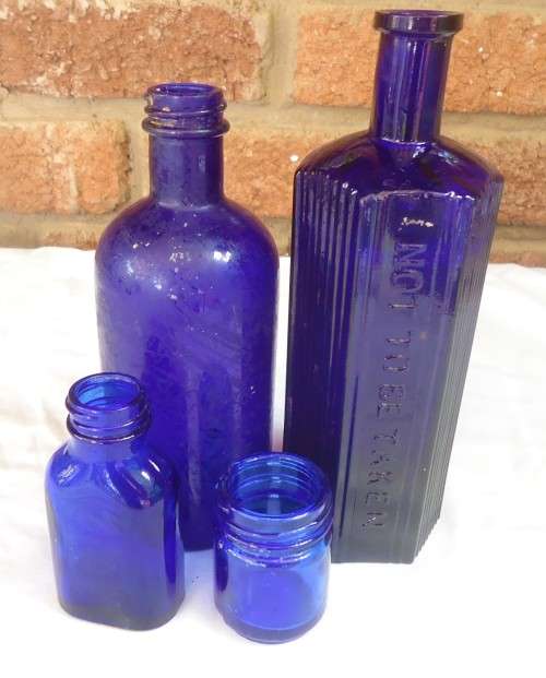 SET OF FOUR COBALT GLASS BOTTLES IN DIFERENT SIZES