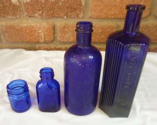 SET OF FOUR COBALT GLASS BOTTLES IN DIFERENT SIZES