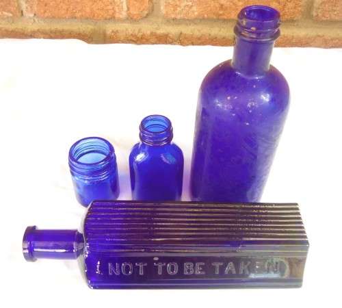 SET OF FOUR COBALT GLASS BOTTLES IN DIFERENT SIZES