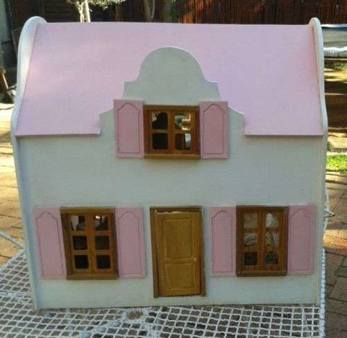 Dolls House made of wood with miniature furniture.