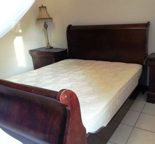 Sleigh bed, queen size with mattress. Side tables, bedding or decor not included