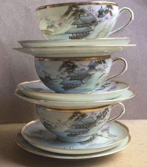 Japanese Handpainted Eggshell Trios x 5, cups by one artist, saucers plates another. Bid per each