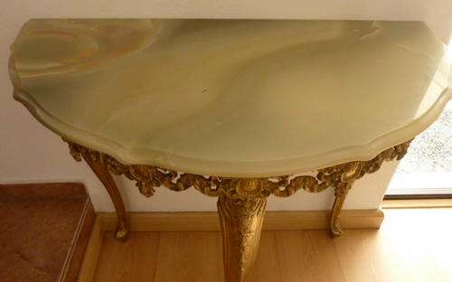 Bronze half moon table with marble top.
