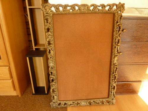 Gold coloured ornate mirror frame