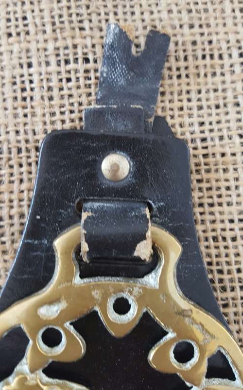 TWO HORSE BRASSES ON A LEATHER STRAP