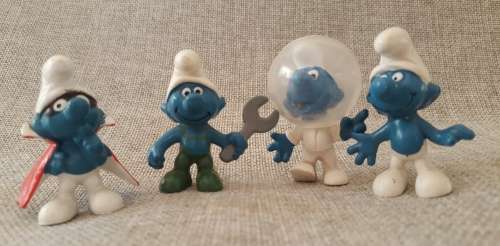 Four Vintage Smurfs, including highly collectable Astro Smurf &  Super Hero Smurf