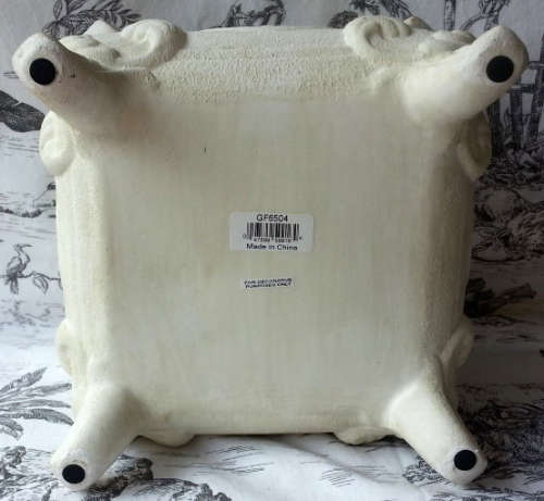 ATTRACTIVE, PAINTED OFF WHITE, ANTIQUED METAL POT PLANT HOLDER ON FOUR LEGS.