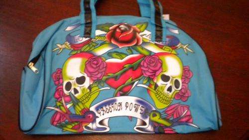Blue luggage bag with Ed Hardy design