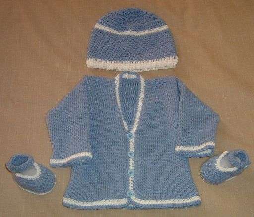 Baby knitted cardigan, hat and bootie set.