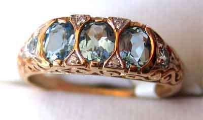 A   9ct. Solid Gold and Genuine Aquamarines and Diamonds Ring.