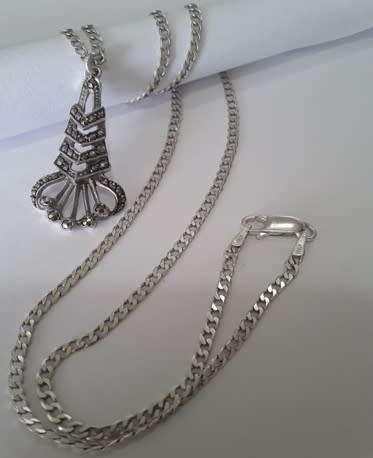 A sterling silver neck chain with sterling silver and marcasite pendant.  Wow!!!
