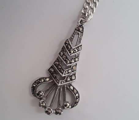 A sterling silver neck chain with sterling silver and marcasite pendant.  Wow!!!