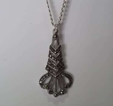 A sterling silver neck chain with sterling silver and marcasite pendant.  Wow!!!