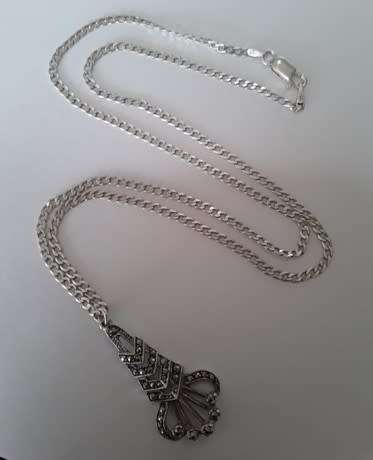 A sterling silver neck chain with sterling silver and marcasite pendant.  Wow!!!