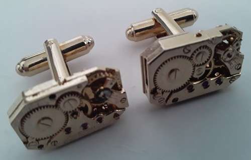 Pair gold-plated `Excello Watch Co` clock movement cufflinks.