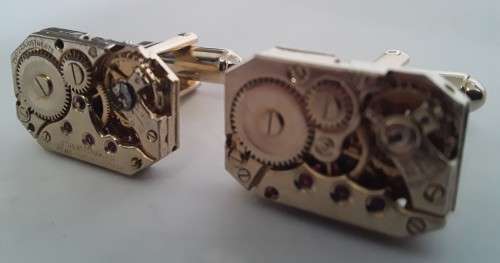 Pair gold-plated `Excello Watch Co` clock movement cufflinks.