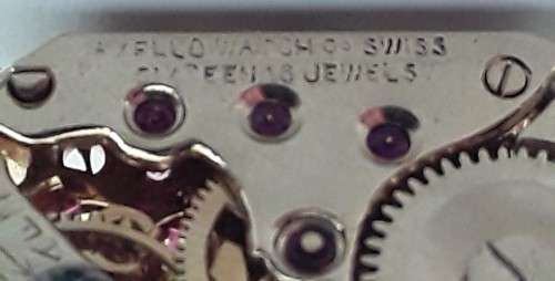 Pair gold-plated `Excello Watch Co` clock movement cufflinks.