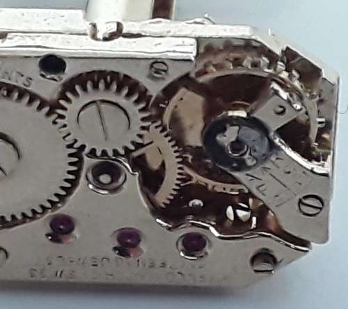 Pair gold-plated `Excello Watch Co` clock movement cufflinks.