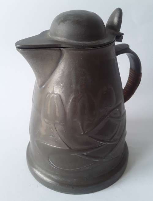 Antique Arts and Crafts pewter jug in the style of Liberty and Co. Hand-beaten lily pattern.