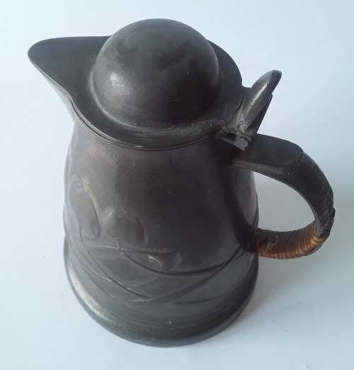 Antique Arts and Crafts pewter jug in the style of Liberty and Co. Hand-beaten lily pattern.