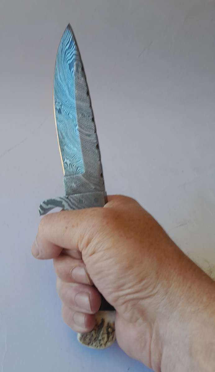 A Superb Damascus Blade Hunting Knife With Leather Sheath And Display Stand.