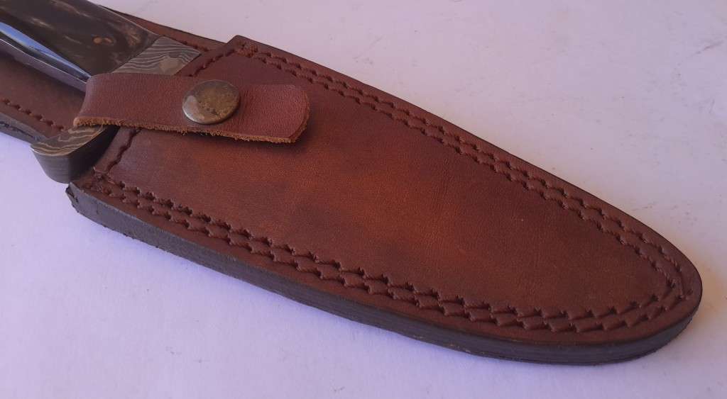 A Superb Damascus Blade Hunting Knife With Leather Sheath And Display Stand.