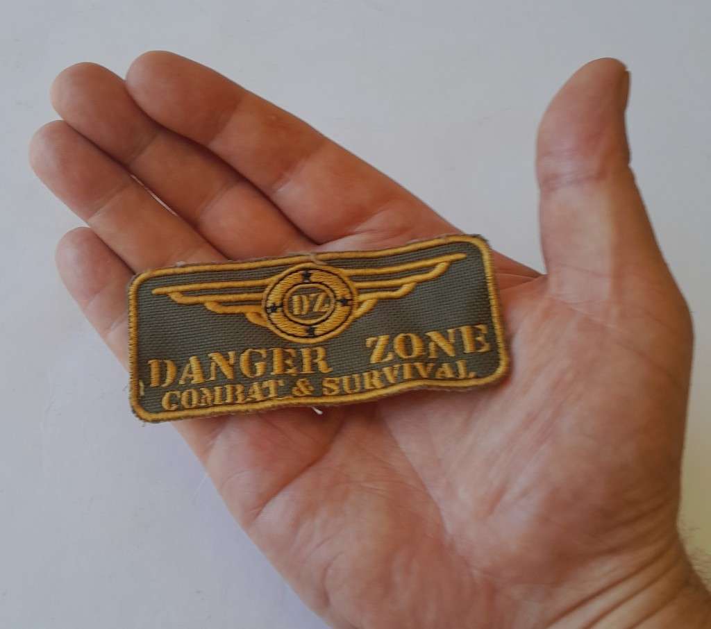 Large `Danger Zone Combat & Survival` Badge.