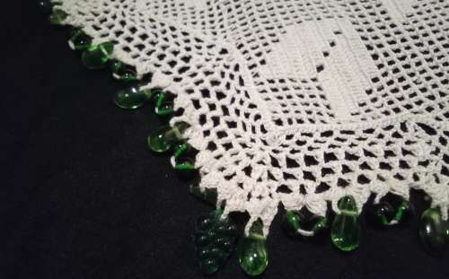 White Vintage crocheted jug cover with green glass beads