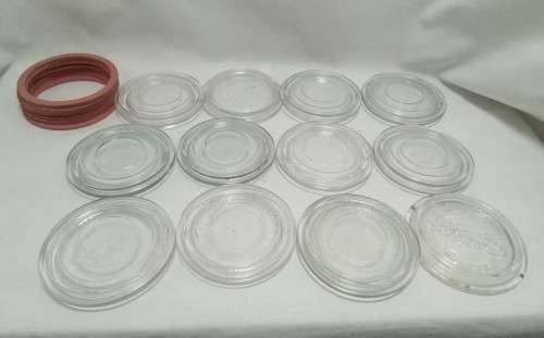 Twelve vintage Consol bottle glass lids & 10 elastic rings