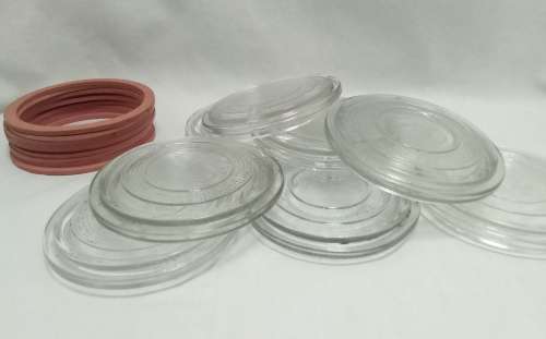 Twelve vintage Consol bottle glass lids & 10 elastic rings