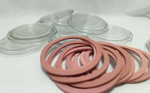 Twelve vintage Consol bottle glass lids & 10 elastic rings