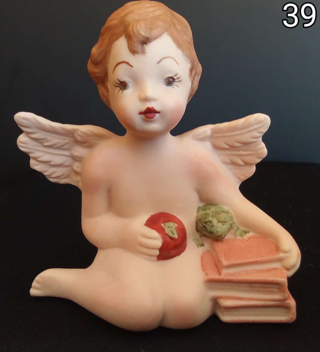Beautiful  hand painted porcelain Angel with orange books