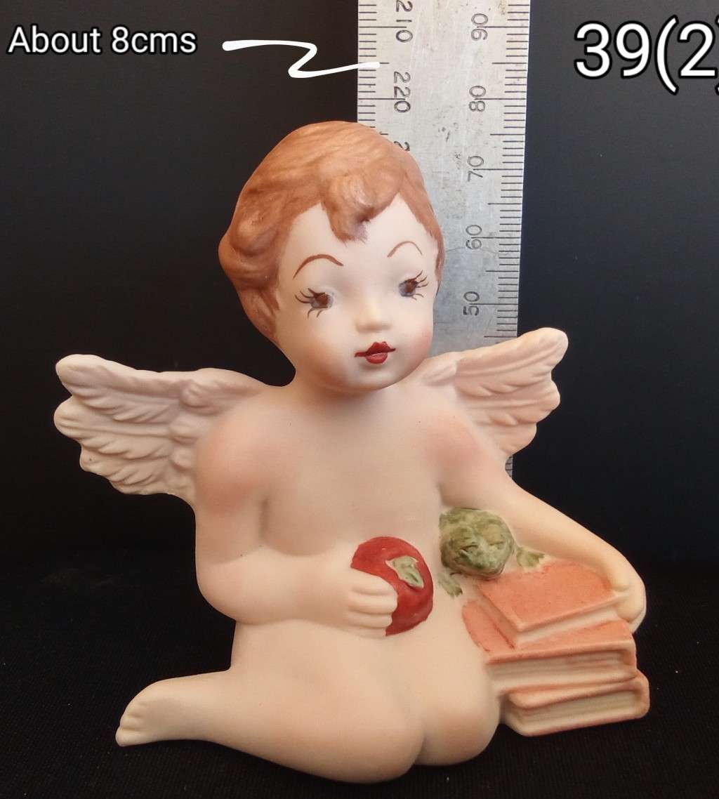 Beautiful  hand painted porcelain Angel with orange books