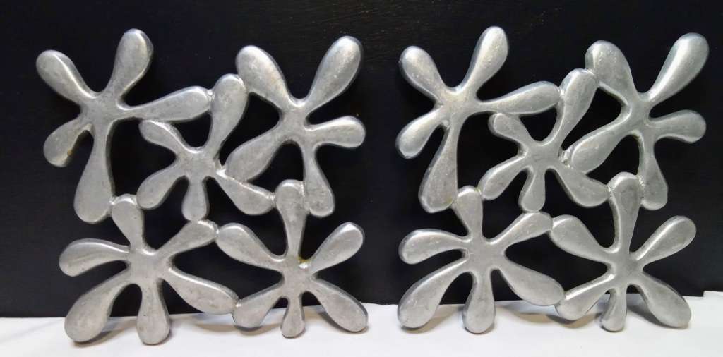 Two vintage aluminium trivets
