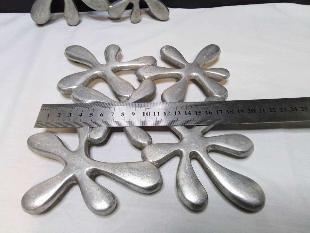 Two vintage aluminium trivets