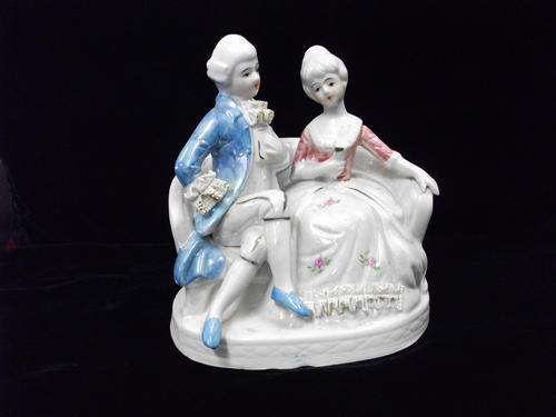 SEATED MAN AND LADY ON A BENCH