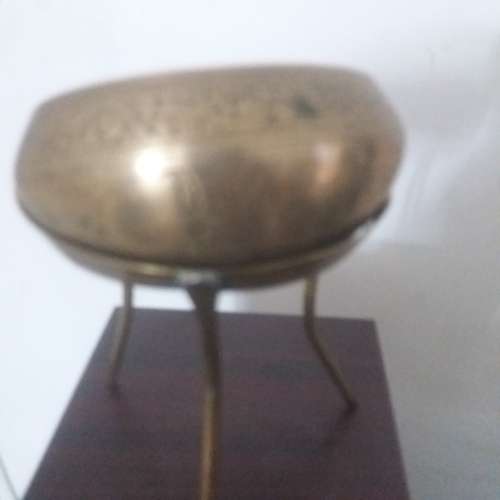 Ornate brass bowl on a stand holding a vase - stunning of craftsmanship piece- different