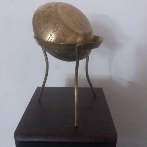 Ornate brass bowl on a stand holding a vase - stunning of craftsmanship piece- different