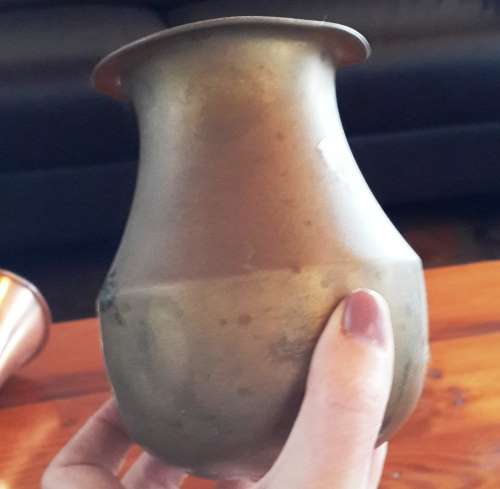 Old and slightly dented. Unpolished