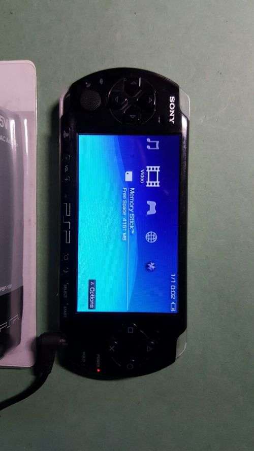 SONY PSP - MODEL: 3004 - 2 GAMES AND CHARGER - 8 GB SONY MEMORY CARD