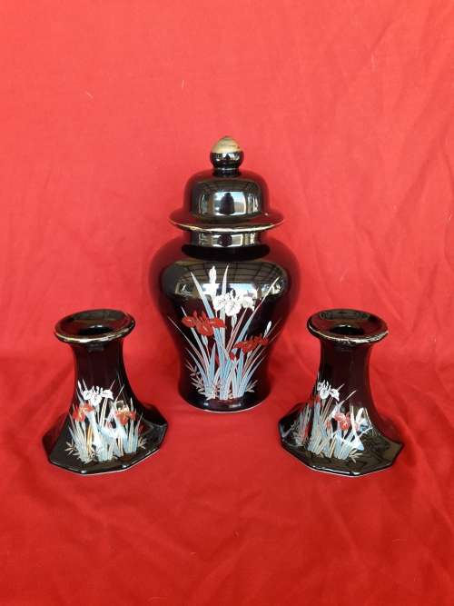 A beautiful decorative ginger jar and candlestick holder set