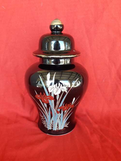 A beautiful decorative ginger jar and candlestick holder set