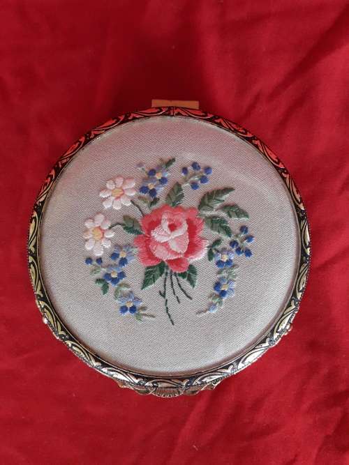A petit point embroidered powder box