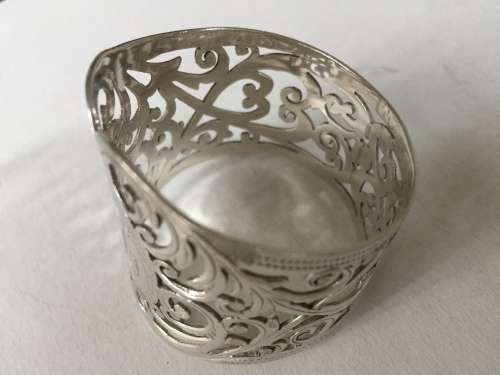Solid silver decorative napkin rings and spoons