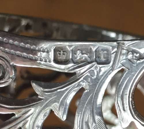 Solid silver decorative napkin rings and spoons