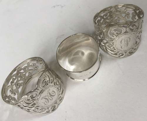 Solid silver decorative napkin rings and spoons